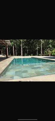 a large swimming pool with blue water at Casa el Silencio in Arbolito