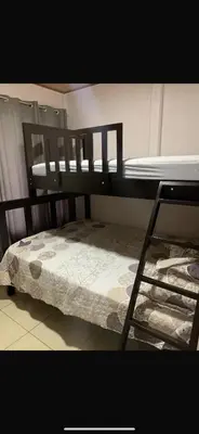 a bedroom with two bunk beds and a ladder at Casa el Silencio in Arbolito