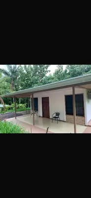 a building with a patio and a table in front of it at Casa el Silencio in Arbolito