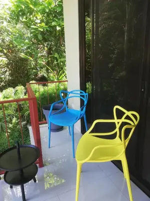 three chairs and a table on a porch at Coyaba Tropical Elegant Adult Guesthouse in Manuel Antonio