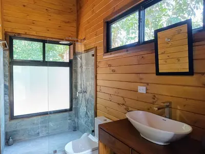a bathroom with a sink and a toilet and windows at Thoas Lodge in Coronado