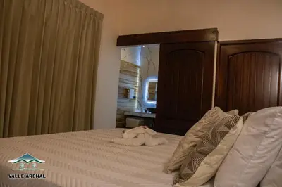 a bedroom with a bed with a stuffed animal on it at Valle Arenal in Fortuna