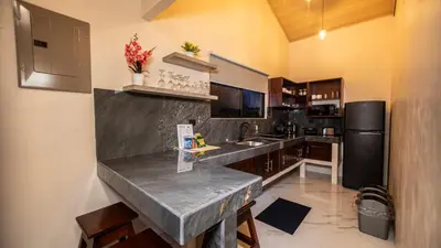 a kitchen with a marble counter top and a refrigerator at Valle Arenal in Fortuna