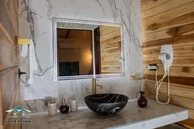 a bathroom with a black sink and a mirror at Valle Arenal in Fortuna