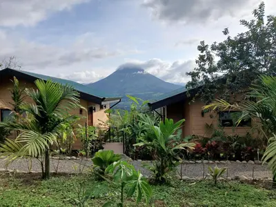 a house with a mountain in the background at Valle Arenal in Fortuna
