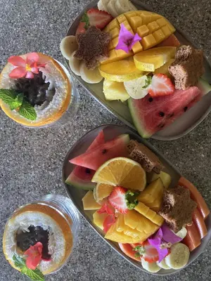 three plates of food with fruit on a table at Casa Oh - Oceanview Guesthouse in Uvita