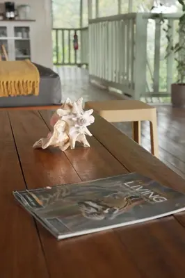 a wooden table with a book and a starfish on it at Casa Oh - Oceanview Guesthouse in Uvita