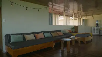 a living room with a couch and a table at Casa Oh - Oceanview Guesthouse in Uvita