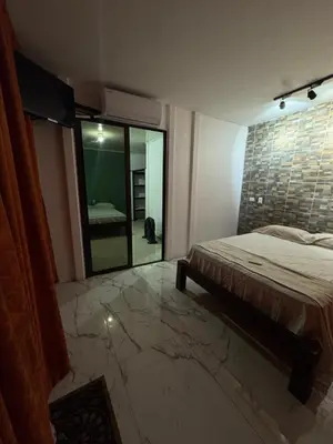 a bedroom with a bed and a large mirror at Casa Leona in Quepos