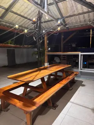 a wooden picnic table sitting inside of a building at Casa Leona in Quepos