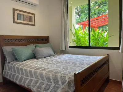 a bed in a bedroom with a large window at Coco Sunset Hills #42 in Coco