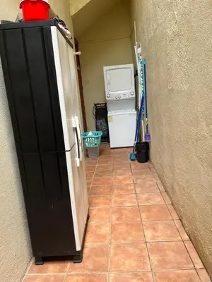 a hallway with a refrigerator in a room with a kitchen at Coco Sunset Hills #42 in Coco