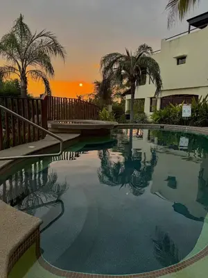 a swimming pool with a sunset in the background at Coco Sunset Hills #42 in Coco