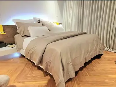 a bedroom with a large bed with white pillows at Lujo al atardecer en Rohrmoser in San José