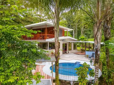 an aerial view of a house with a pool and trees at La Maison de Vénus in Tortugal