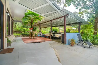 a patio with awning and a table and chairs at La Maison de Vénus in Tortugal