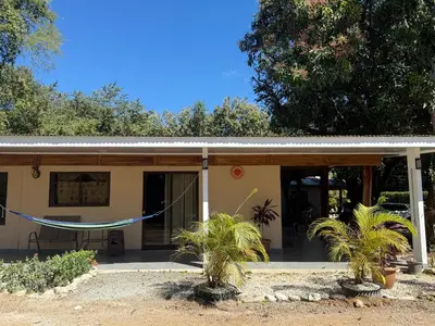 a house with a hammock in front of it at cabina DiTi 2 in Santa Cruz
