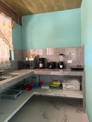 a kitchen with a shelf with some pots and pans at cabina DiTi 2 in Santa Cruz