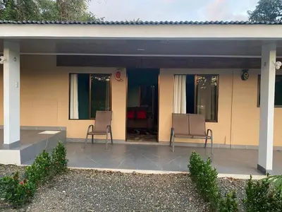 a patio with two chairs and a house at Casa DiTi 3 in Paraíso
