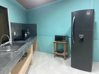 a kitchen with a black refrigerator and a sink at Casa DiTi 3 in Paraíso