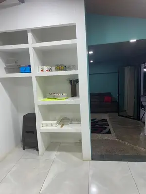 a room with white shelves in a room at Casa DiTi 3 in Paraíso