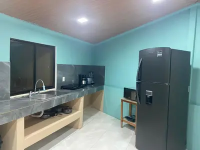 a kitchen with a black refrigerator and a sink at Casa DiTi 3 in Paraíso