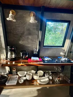 a kitchen with a counter with white dishes on it at Chalet de los ciervos in Isla Cabuya