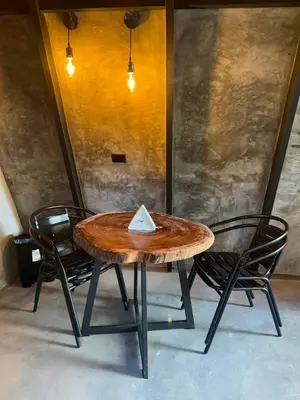 a wooden table with two chairs and a table with a plaque on it at Chalet de los ciervos in Isla Cabuya