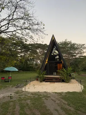 a small house sitting on top of a field at Chalet de los ciervos in Isla Cabuya