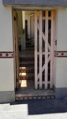 an open door of a building with a wooden gate at Morada Kampos in Heredia
