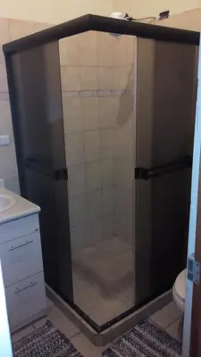 a shower with a glass door in a bathroom at Morada Kampos in Heredia