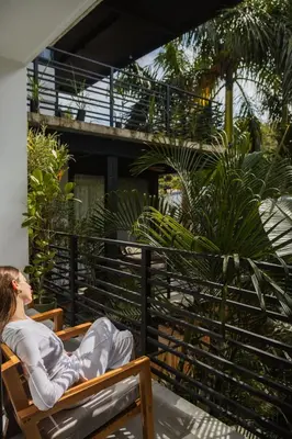 a woman is sitting in a chair in avisor at Casa Swell Boutique Hotel Santa Teresa in Santa Teresa Beach