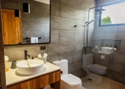a bathroom with a sink and a toilet and a shower at Casa Swell Boutique Hotel Santa Teresa in Santa Teresa Beach