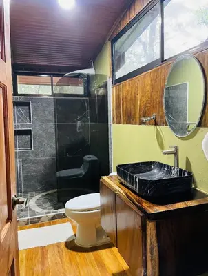 a bathroom with a black sink and a shower at Cabañas La Montaña in Monteverde Costa Rica