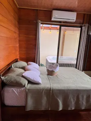 a small bed in a room with a mirror at Vista Lapas Cottage in Guayabal