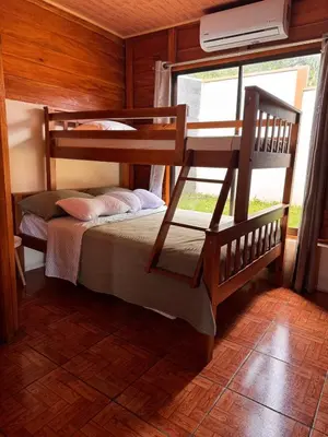 a bedroom with two bunk beds and a window at Vista Lapas Cottage in Guayabal