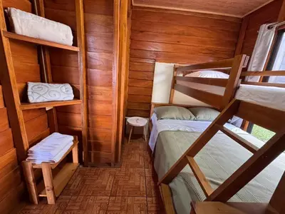 a room with two bunk beds in a cabin at Vista Lapas Cottage in Guayabal