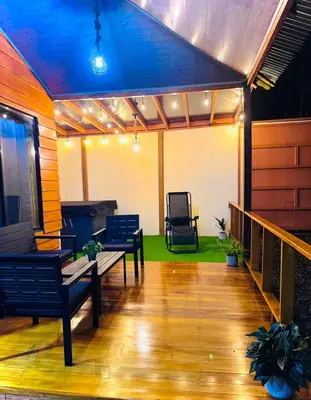 a patio with benches and a blue ceiling at Vista Lapas Cottage in Guayabal
