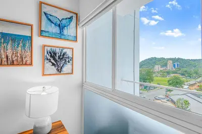 a white room with a large window with a view at Upstay - Brand New Condo w Pool - Near the Beach in Jacó