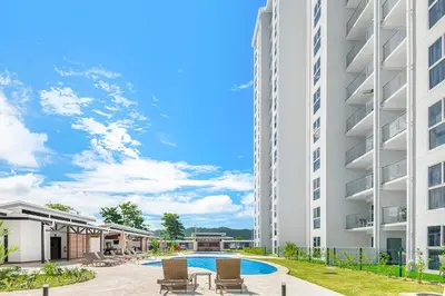 an image of an apartment building with a swimming pool at Upstay - Brand New Condo w Pool - Near the Beach in Jacó