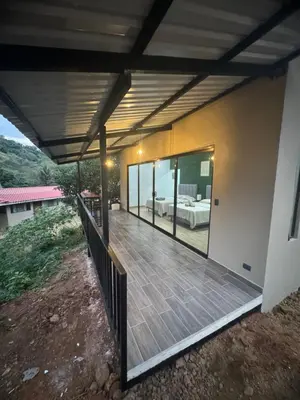 a large deck with a bed in a house at Villa Colibrí a solo 5mins de Playa Carrillo in Hojancha