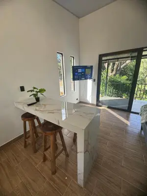 a room with a table and chairs and a window at Villa Colibrí a solo 5mins de Playa Carrillo in Hojancha
