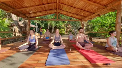 a group of people sitting in a yoga class at Casa Escondida 10min from Carrillo beach in Arbolito