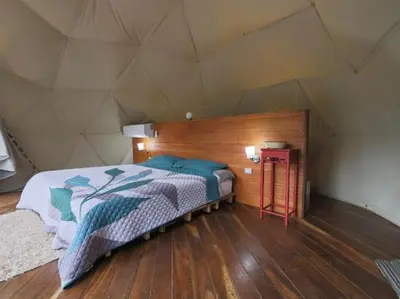 a bedroom with a large bed in a tent at Moonlight glamping in Fortuna