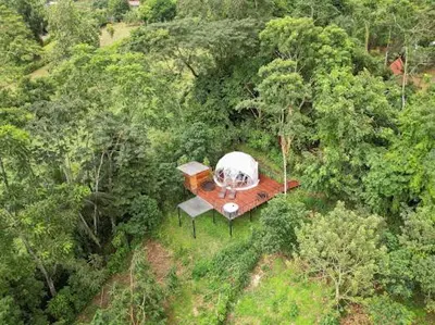 an aerial view of a house in the middle of a forest at Moonlight glamping in Fortuna