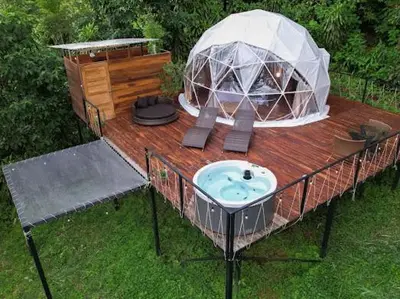 an outside iguanaoir with a gazebo on a deck at Moonlight glamping in Fortuna