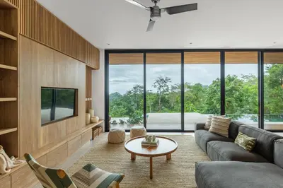 a living room with a couch and a table at Casa Roca in Santa Teresa Beach
