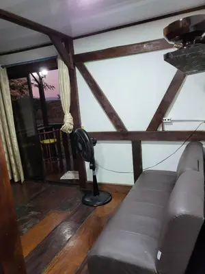 a living room with a couch and a fan at Cabana Luna in Jicaral