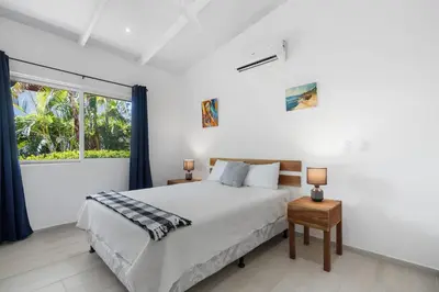 a bedroom with a bed and a large window at 3-BD Home with Pool Near Beach in Brasilito