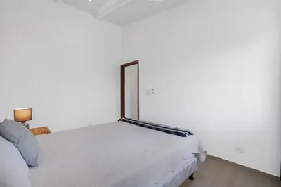 a white bedroom with a bed in a room at 3-BD Home with Pool Near Beach in Brasilito